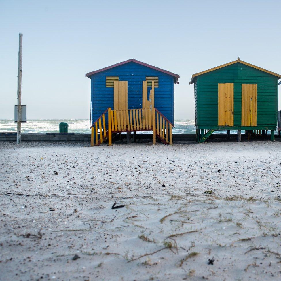 An image of beach houses next to a snow-covered beach