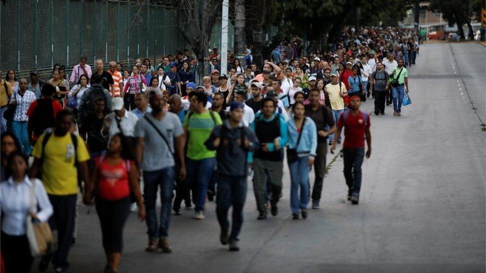 People walk on a street during a blackout in Caracas, Venezuela February 6, 2018.