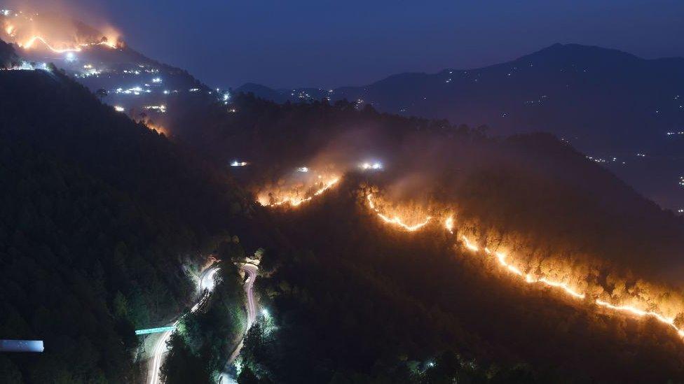 fires burn in hills around New Tehri at Bourari in the Indian state of Uttarakhand on May 24, 2018