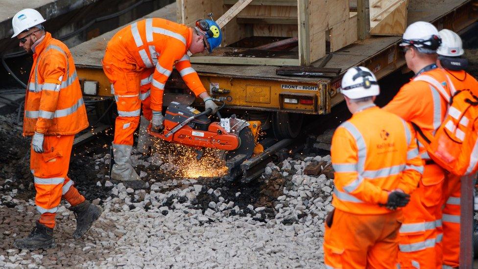 Network Rail workers laying tracks