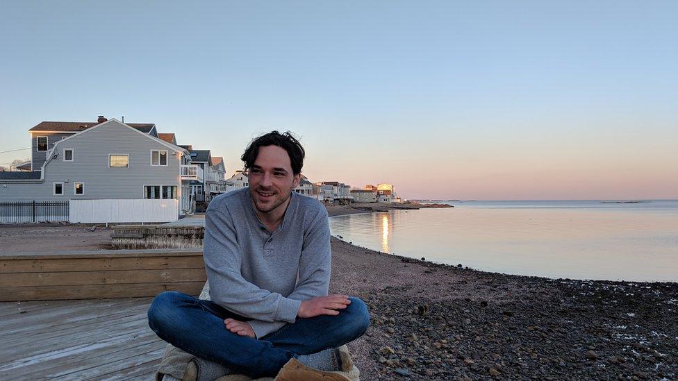 Tyler Shelby, shown at the Connecticut shore, helped put together a contact-tracing team - sitting near water