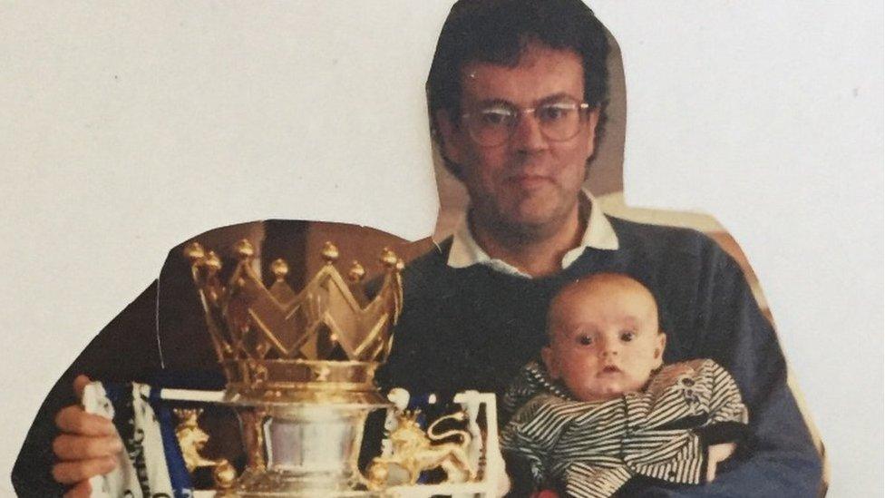 Paddy at two months old with the Premier League trophy.