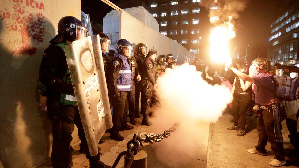 Demonstrators face off with police officers during a protest against femicide and violence against women, in Mexico City, Mexico, 25 November, 2019.