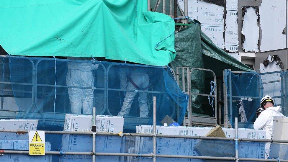 Police on scaffolding at site of Luton flats fire