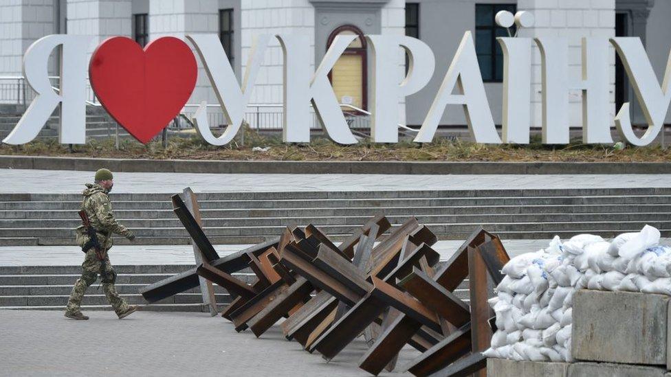 Soldier walks past defence barriers in Kyiv