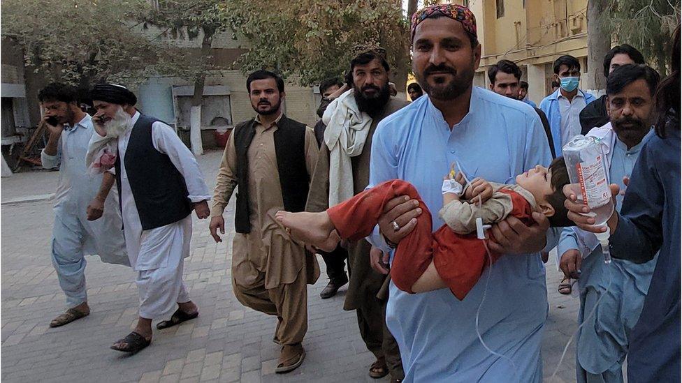 People shift an injured victim, after a 5.9 magnitude earthquake with a shallow depth of nine kilometres struck Harnai, to a hospital in Quetta, Balochistan province, Pakistan, 7 October 2021.