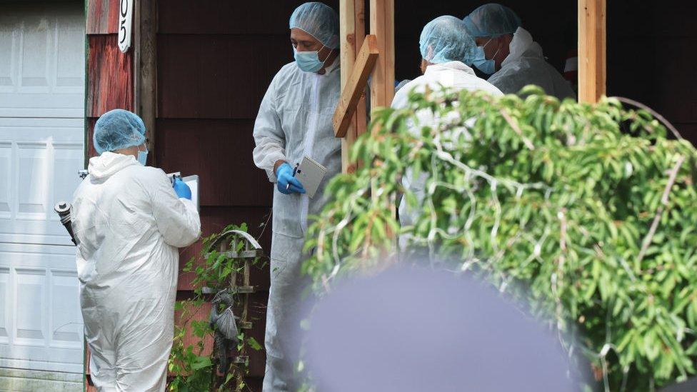 Investigators at the Heuermann home