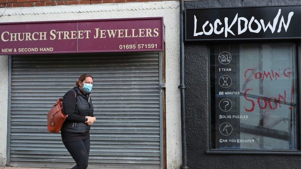 A woman walks down the street in Ormskirk, Lancashire