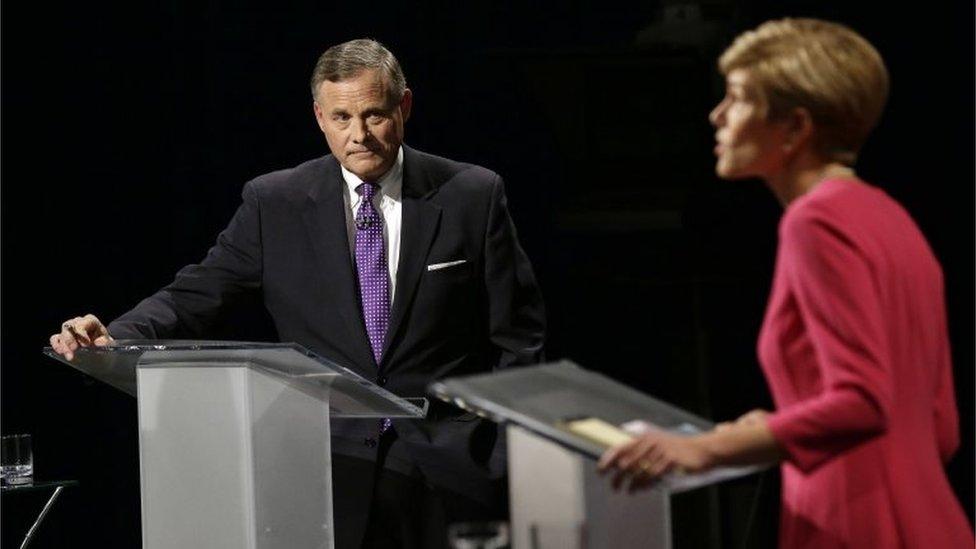 US Senator Richard Burr (L) listens to Democratic challenger Deborah Ross (R) during a live televised Senate debate in Research Park Triangle, North Carolina.