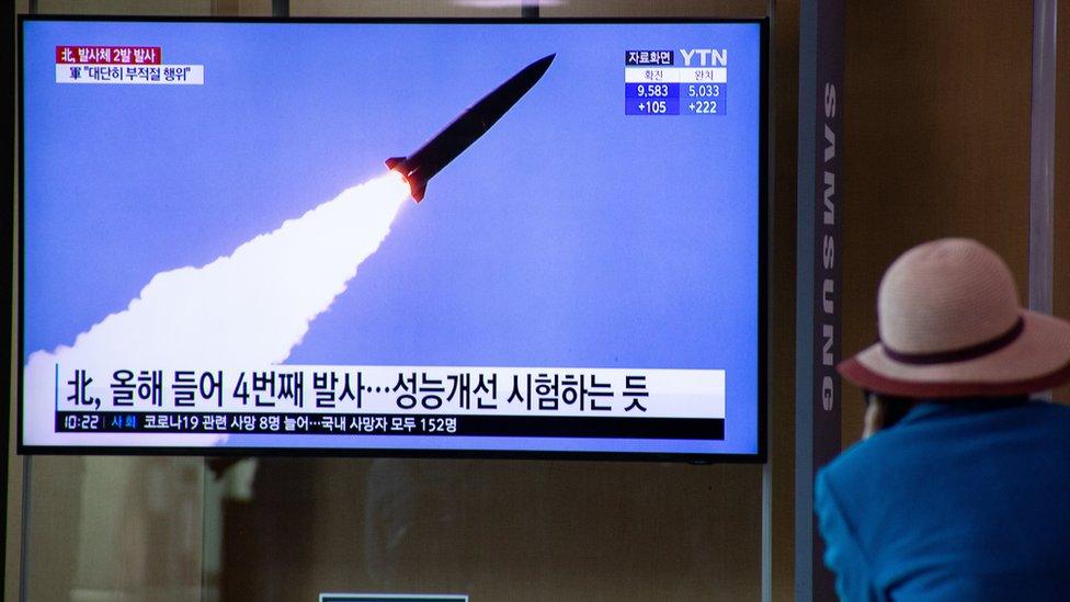 A man watches breaking news of North Korea's latest projectile launch, on a TV screen at Seoul Station in Seoul