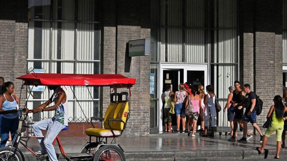 Cubans queue outside a bank in Havana, on August 4, 2022.