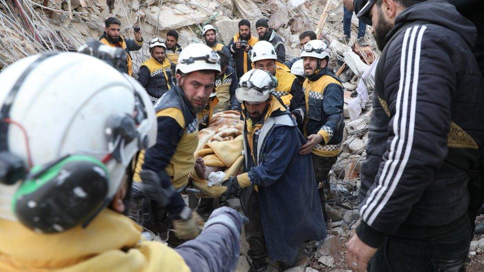 White Helmets rescue teams extracting a casualty from rubble in northern Syria