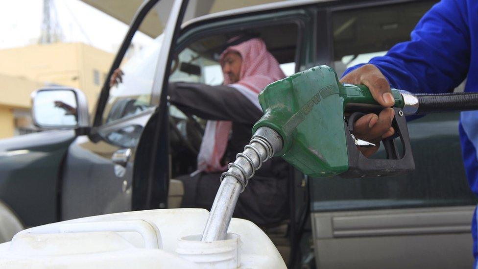 An employee fills a container with diesel at a petrol station in Riyadh (19 December 2012)