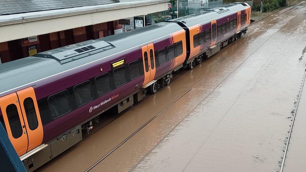 Train on flooded railway line at Wellington station, in Shropshire