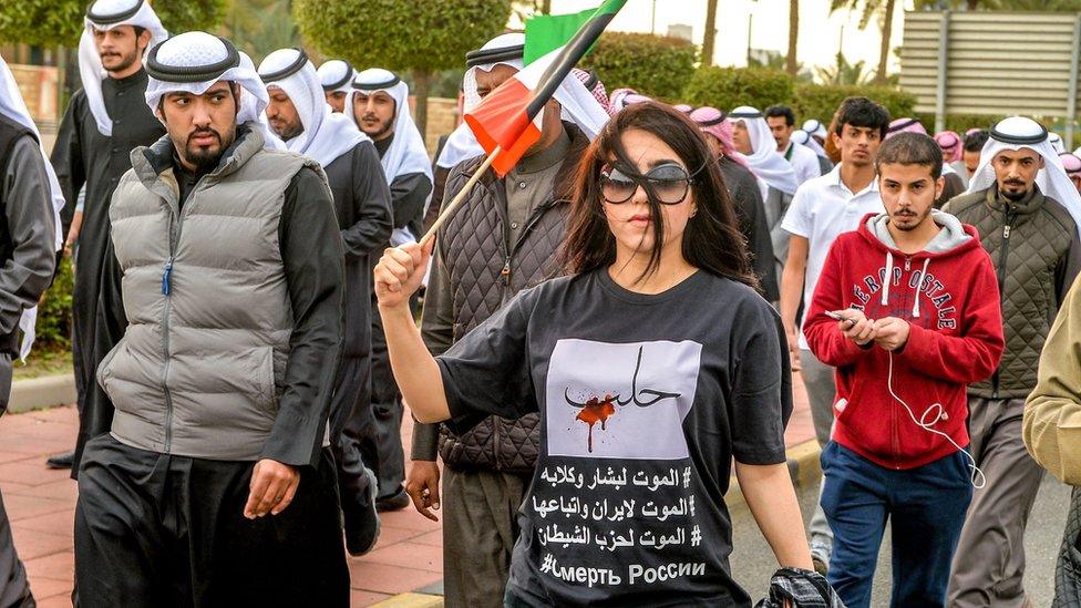 A Kuwaiti protester wearing a t-shirt with inscription reading in Arabic "Aleppo, death to Russia, Iran, Bashar and the party of devil" during a protest in front of the Russian Embassy in Kuwait City, Kuwait,