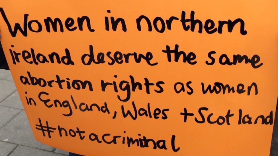 Placard reading: Women in Northern Ireland deserve the same abortion rights as women in England, Wales and Scotland #notacriminal"