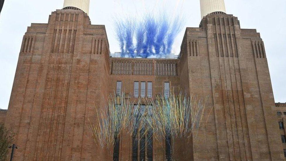 Multicoloured streamers explode in front of Battersea Power Station