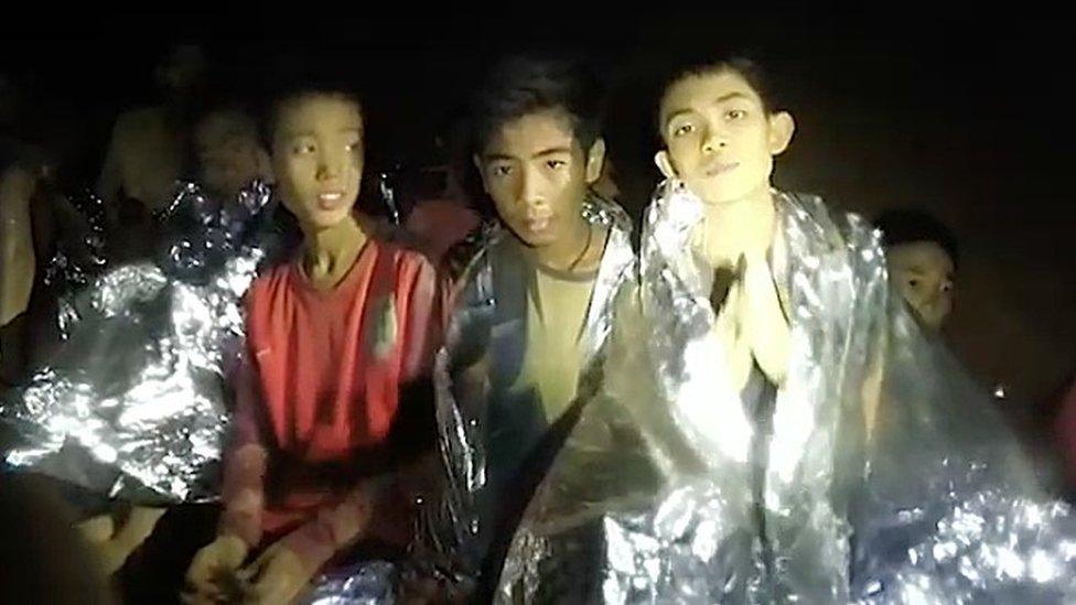 A video grab handout made available by the Thai Navy SEALs shows some of the members of a soccer team in a section of Tham Luang cave in Khun Nam Nang Non Forest Park