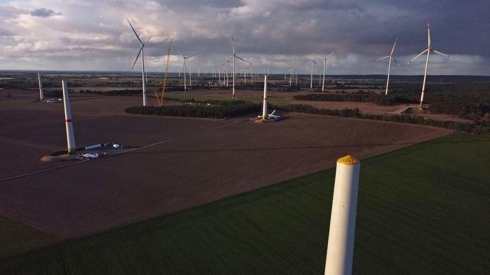 New wind turbines stand under construction at a wind farm on October 12, 2021 near Biegen, Germany.