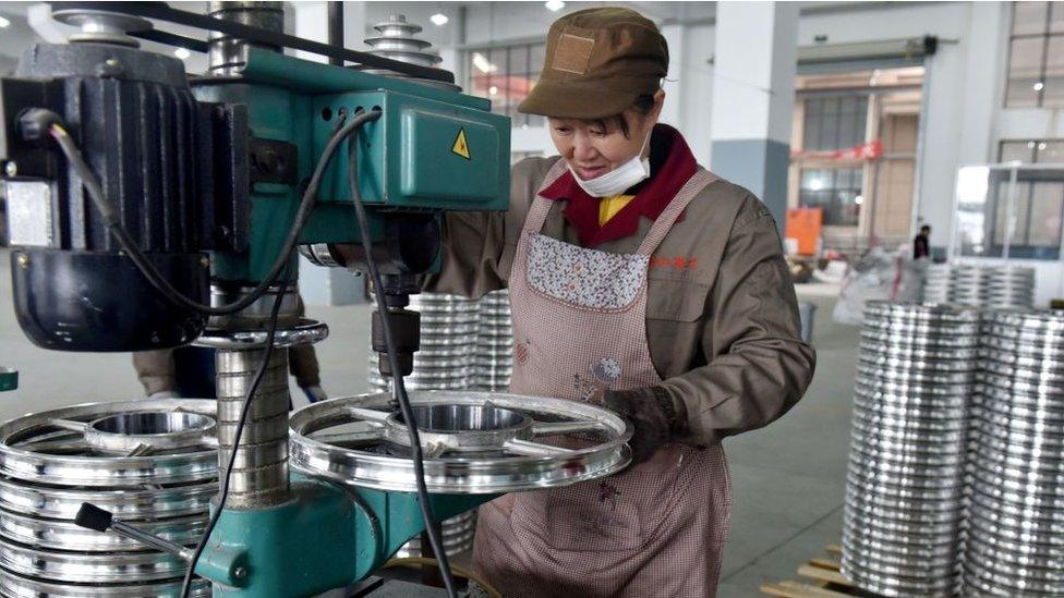 Worker in China making a bike