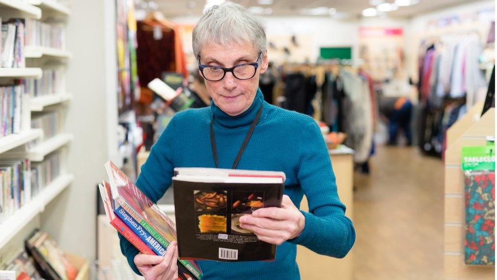 Oxfam volunteer Janet sorts books at Wimbledon shop