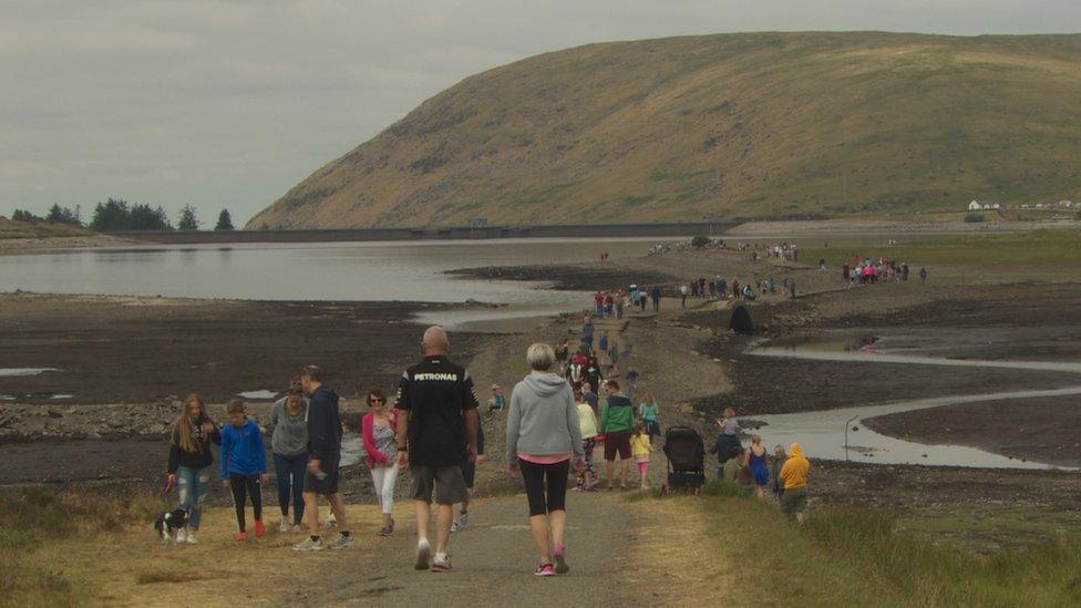 People walking along the old road at Spelga Reservoir