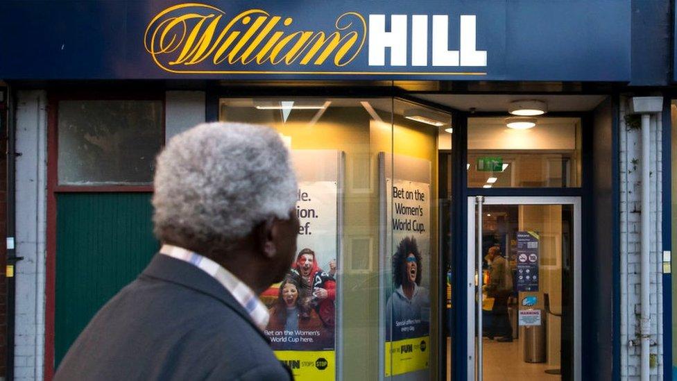 A man looks at a William Hill betting shop