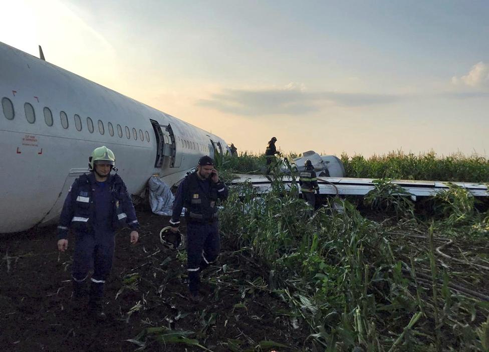 Rescue crews are seen attending to the Ural Airlines Airbus 321 plane after its emergency landing near Zhukovsky International Airport in Moscow Region, Russia.