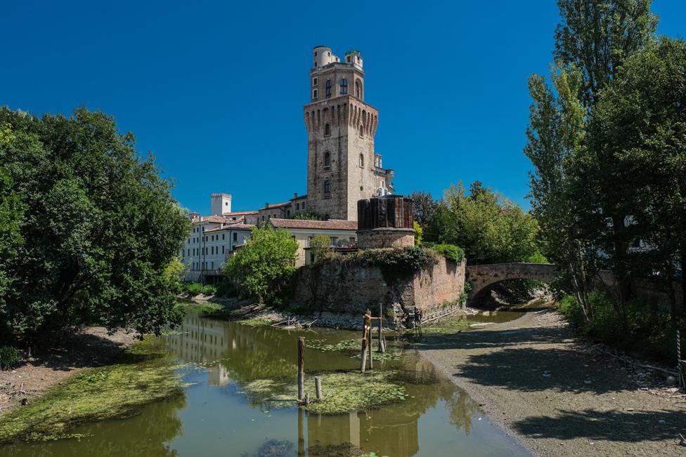 A tributary of the Bacchiglione di Padova, with the Specola in the background, Padua, Italy.