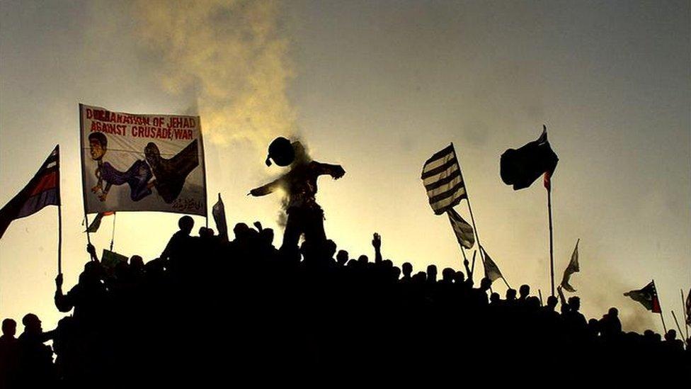 Pro-Taliban demonstrators shout anti-American slogans as they burn an effigy of President George W Bush during a rally in Quetta October 2001.