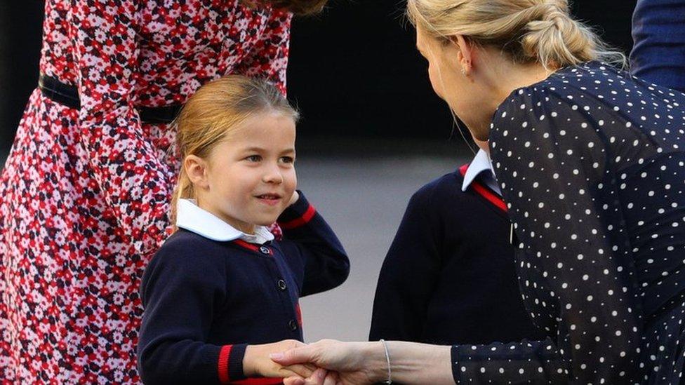 Princess Charlotte shakes hands with the head of the lower school