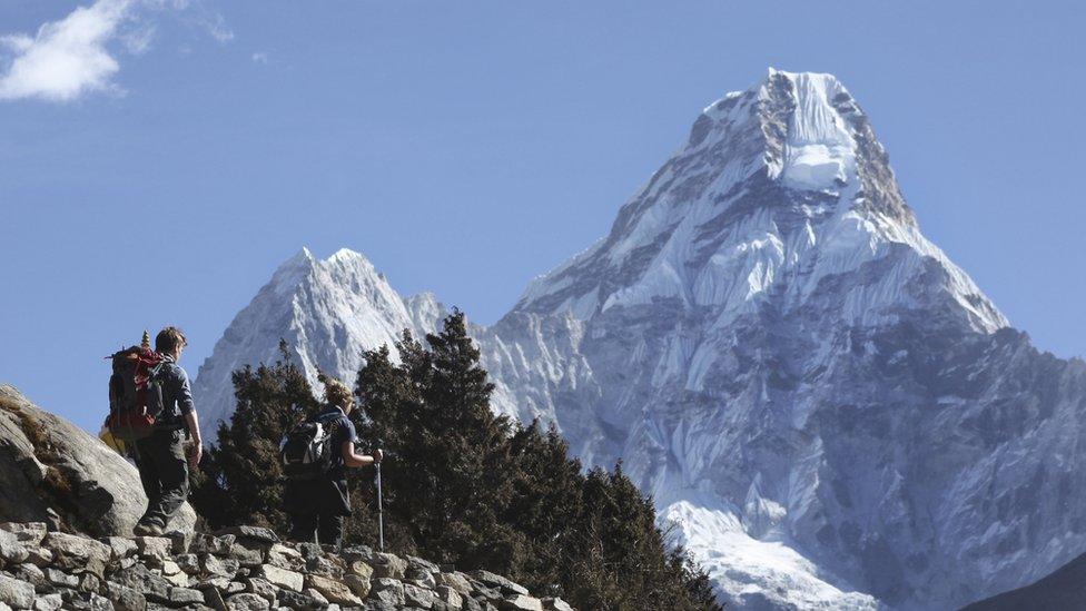 In this Feb. 19, 2016, file photo, trekkers make their way to Dingboche, a popular Mount Everest base camp, in Pangboche, Nepal.