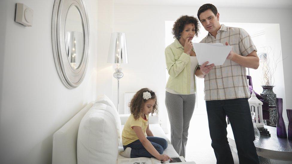 Couple looks at bill - stock shot