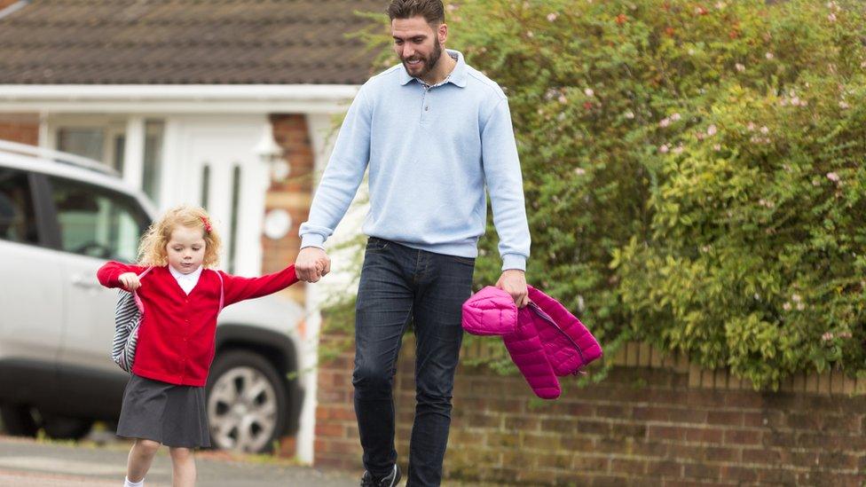 father taking daughter to school