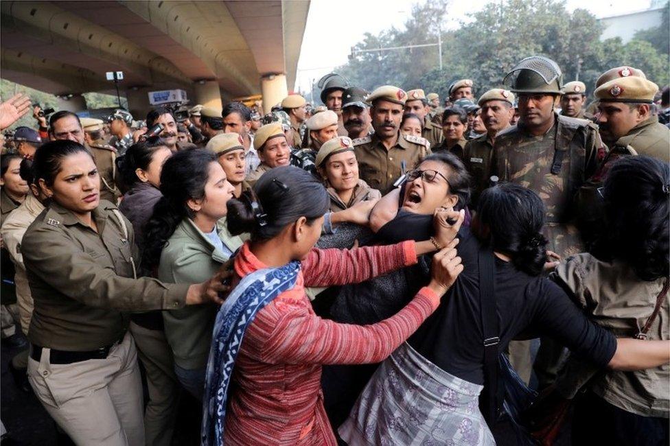 Police officers try to detain a student of Jawaharlal Nehru University (JNU) during a march to Rashtrapati Bhavan to protest against a proposed fee hike, in New Delhi, India, December 9, 2019.