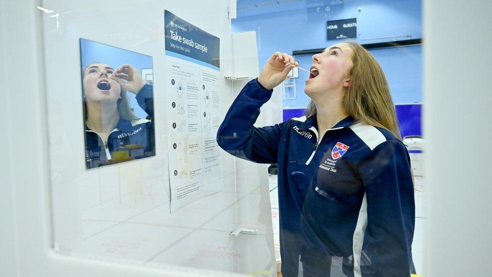 A student at St Andrew University participates in testing of a lateral flow antigen test facility