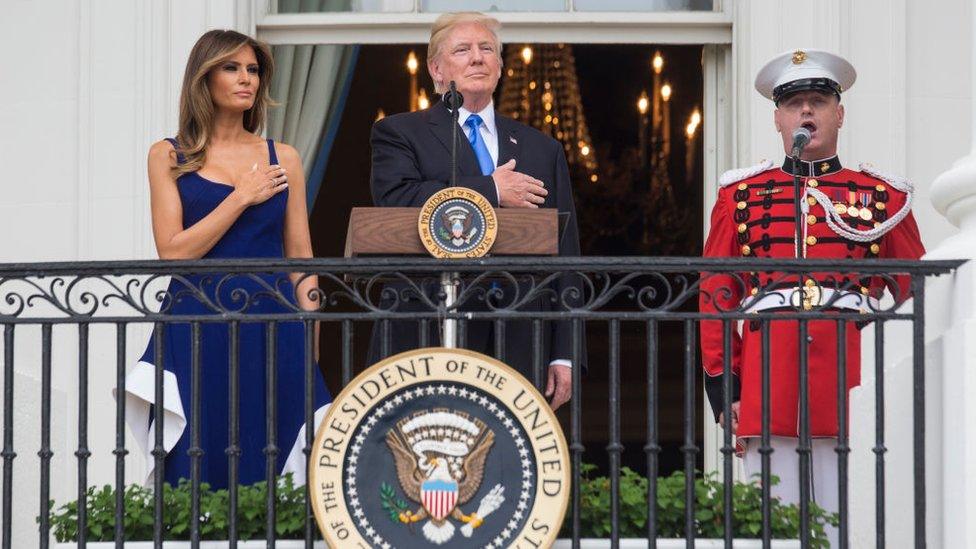 US President Donald Trump and first lady Melania Trump observe the playing of the national anthem from the Truman Balcony on July 4, 2017 in Washington, DC