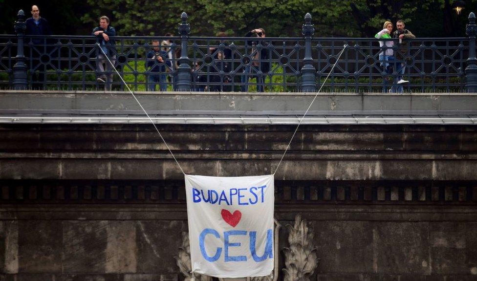 A banner reading "Budapest loves CEU" hangs over the Budapest tunnel, as Students and teachers of the Central European University protest in Budapest with their sympathizers