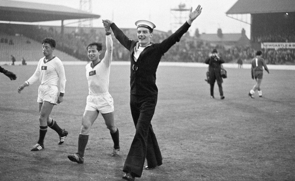 A British sailor parades with the North Korean goalscorer Pak Seung Zin (centre) at Ayresome Park