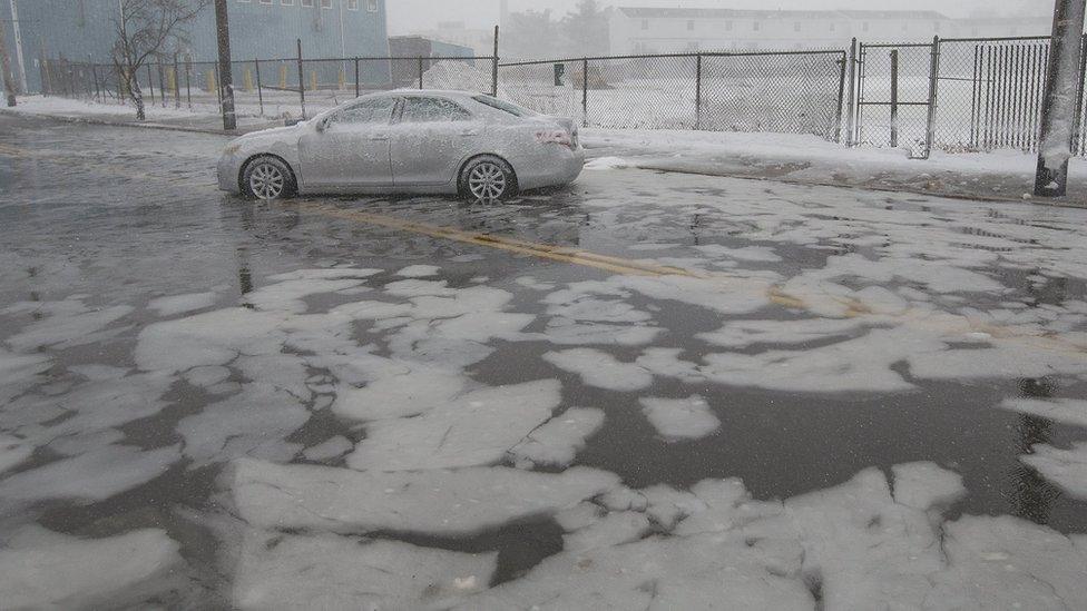 A car is abandoned amid flooding in Massachusetts as a result of a winter storm, 4 January 2018