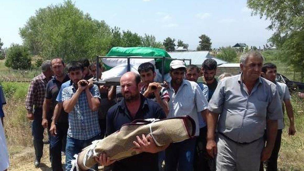 Villagers in Alkhanli bury a 2-year-old girl killed in shelling