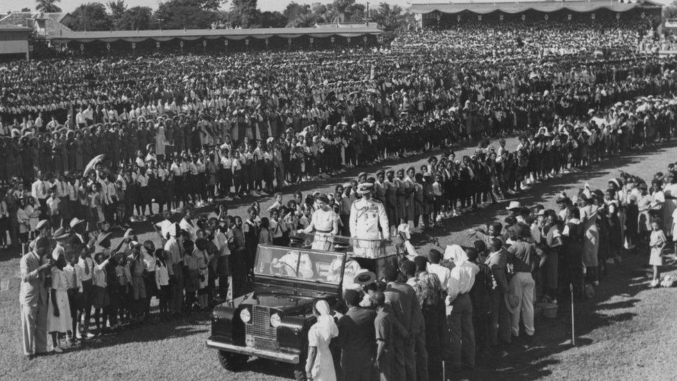 Queen Elizabeth II and Prince Philip in their Land Rover at a children's rally at Sabina Park, Kingston, Jamaica, during the coronation world tour, 25th November 1953.