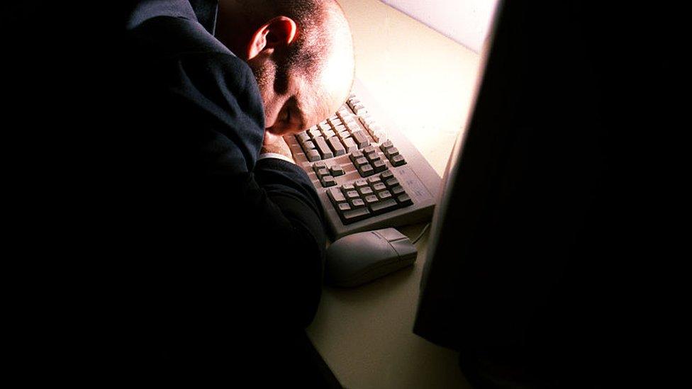 Man asleep at a computer