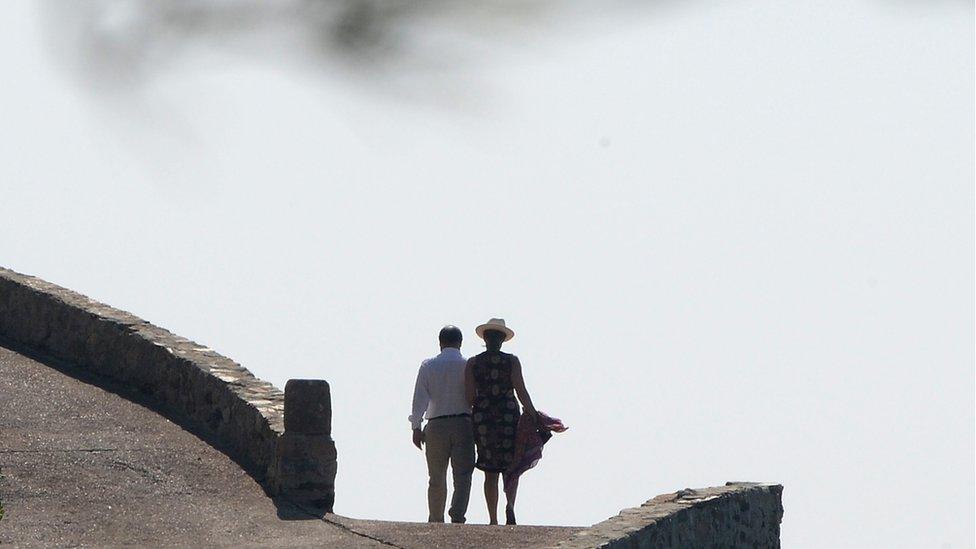 Francois Hollande (L) and his partner Valerie Trierweiler, return from the beach at the Fort de Bregancon in Bormes-les-Mimosas, 2012