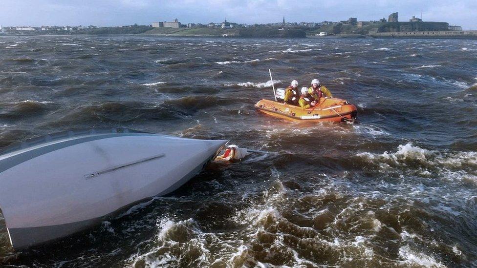 The inshore lifeboat with the capsized dinghy