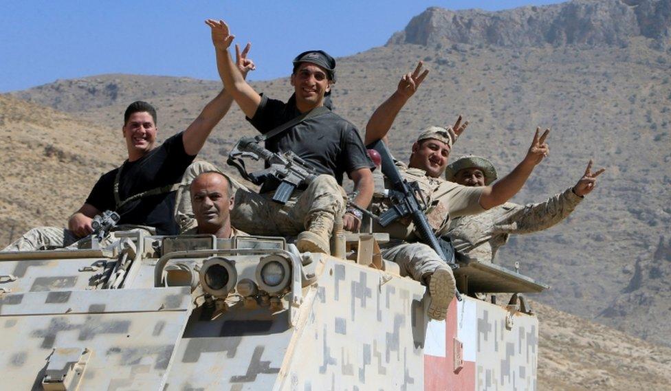 Lebanese army soldiers are seen flashing victory signs in the town of Ras Baalbek, Lebanon August 21, 2017.