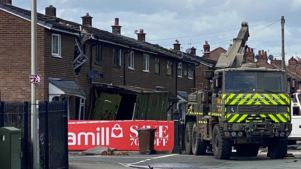 crane and shipping container at house