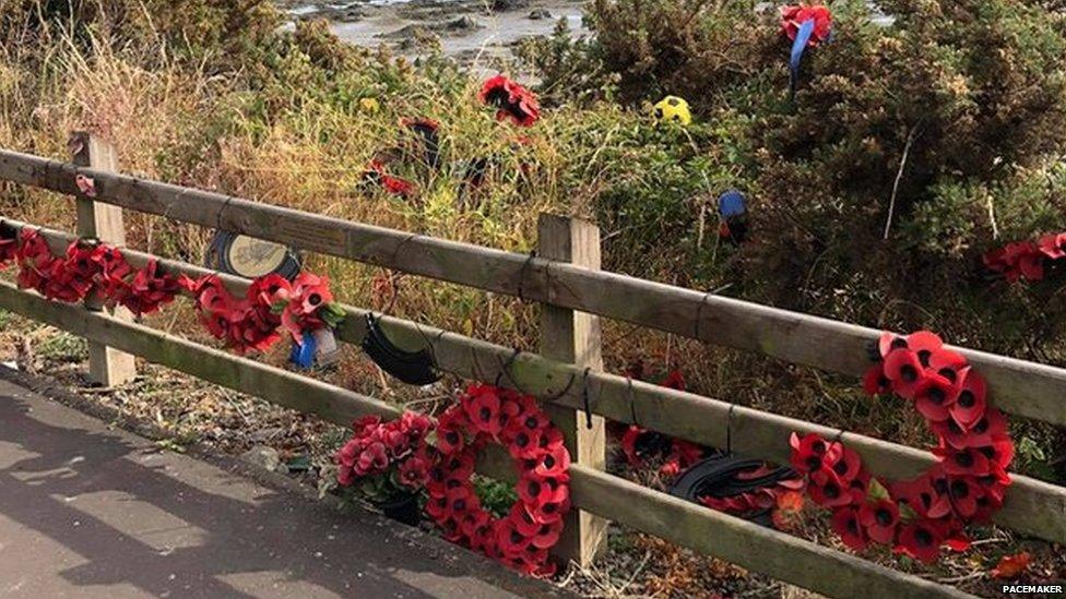 Broken wreaths on a fence