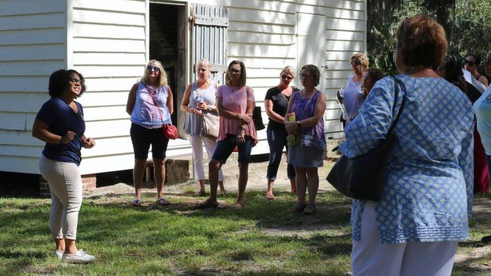 Olivia leading a tour in front of what used to be the kitchens where enslaved women worked