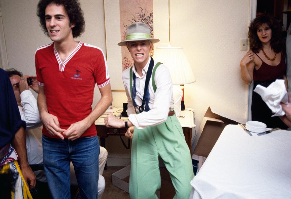 David back in the New York hotel after a show. Still wearing his stage costume and saxophone strap from 'Modern Love', the final song of the set.